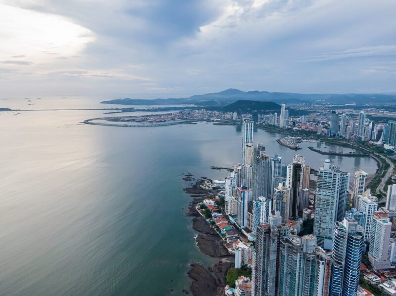 Panama City skyline with modern skyscrapers along the Pacific coastline at sunset